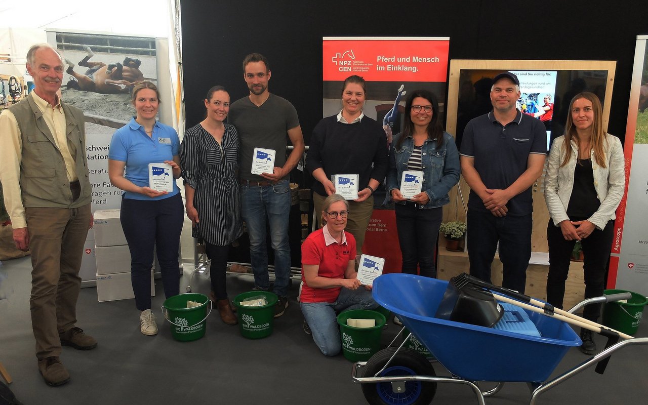 Ein Teil der Ausgezeichneten nahm an der BEA 2023 ihre Plakette entgegen: Organisator Thomas Frei, Anna Boss, Dominique und Christian Künzli, Martina Wey, Gisela Aebersold (sitzend), Gabriella Winistörfer und Jürg Leuenberger sowie Sandra Schaefler von der Fachstelle Heimtiere und Pferde des STS (v.l.).